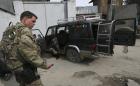 A U.S, soldier from International Security Assistance Force (ISAF) is seen next to a vehicle used by an insurgent, who was killed by security forces in Kabul February 24, 2013. (Reuters)
