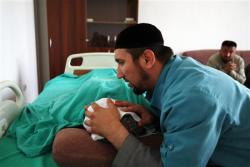 Islamic healer Timur Chamaev places his hands on a patient and recites from the Koran during treatment in the Islamic Medical Centre in the Chechen capital Grozny July 20, 2011. Credit: Reuters/Stringer