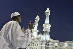 A Muslim pilgrim prays outside Mecca's Grand Mosque, Nov. 15, 2009. (Mahmud Hams/AFP/Getty Images)